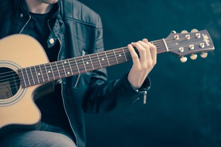 Closeup of musician with acoustic guitar